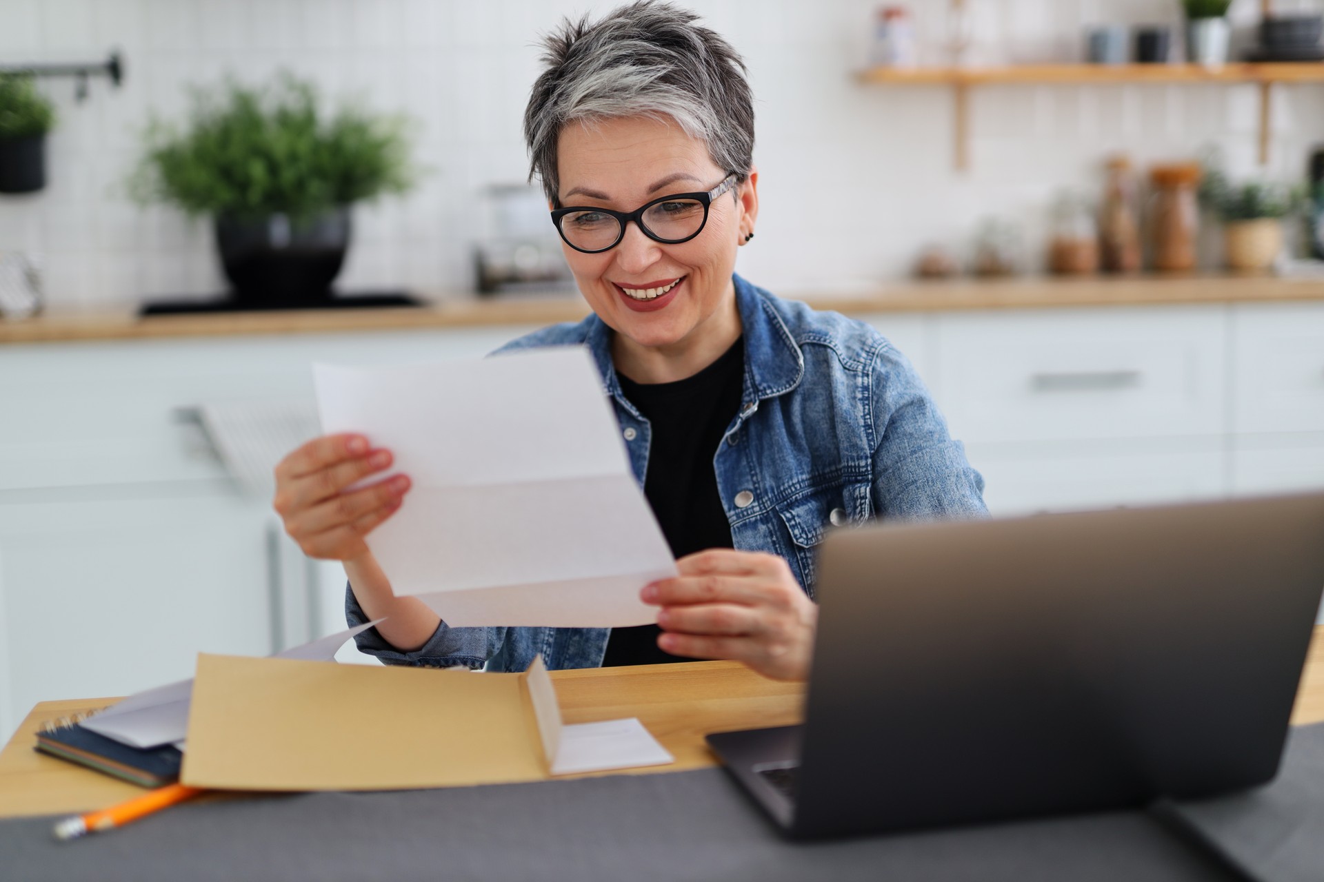 Happy woman holding paper with good news, payout.